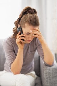 Frustrated young woman talking mobile phone